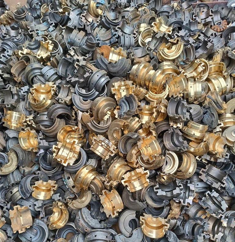 Large pile of brass and metal plumbing fixtures and faucet components for recycling or scrap