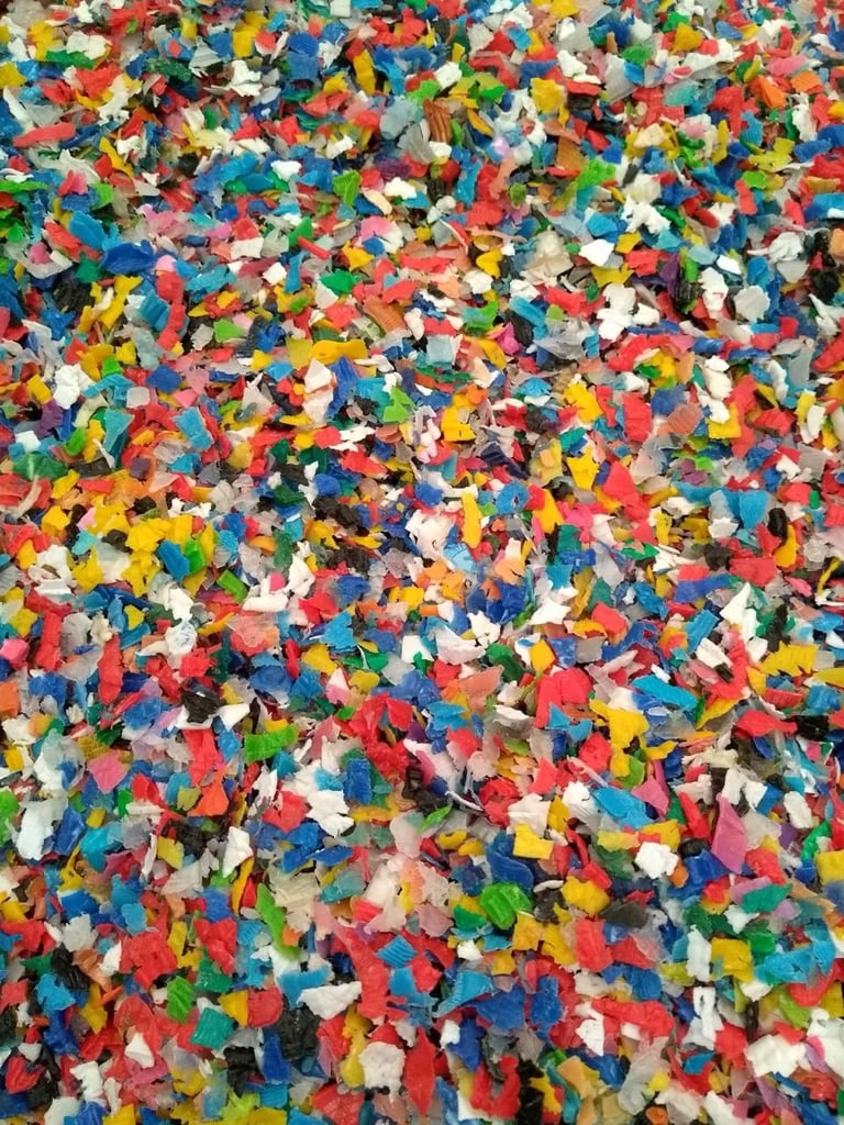 Colorful pile of plastic bricks in red, blue, yellow, green, white, and black scattered closely together